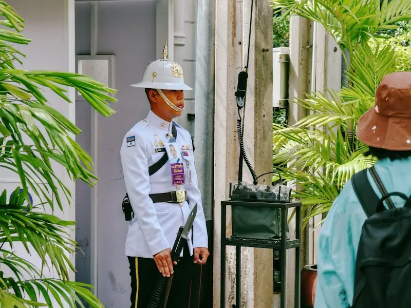 Uniformed security officer standing at a site gate booth